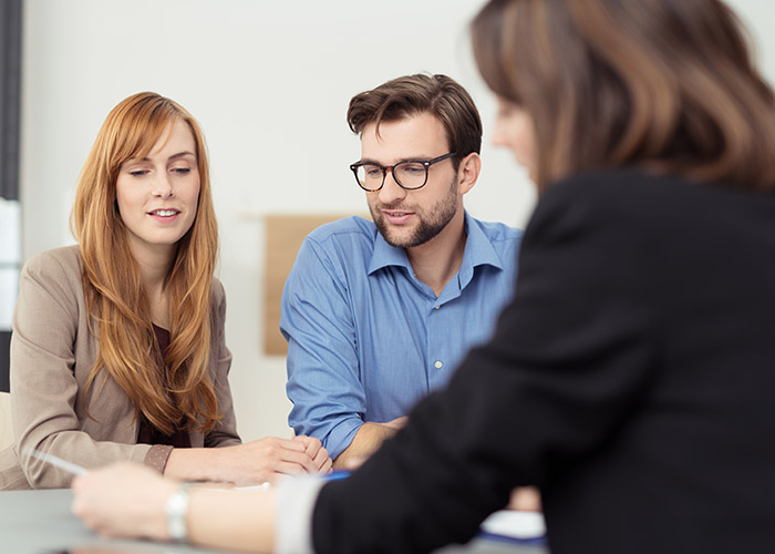A couple sitting across from a financial advisor